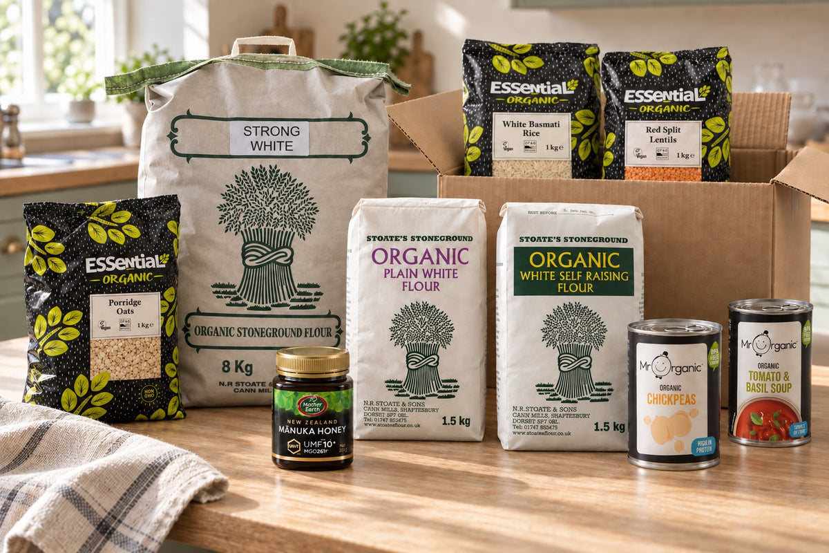 Stoate’s 8kg strong white flour, 1.5kg plain and self-raising flour, honey and groceries beside an open brown box